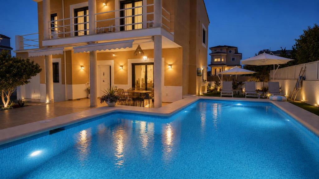 a large swimming pool in front of a house at Casa Lovely in Daimuz