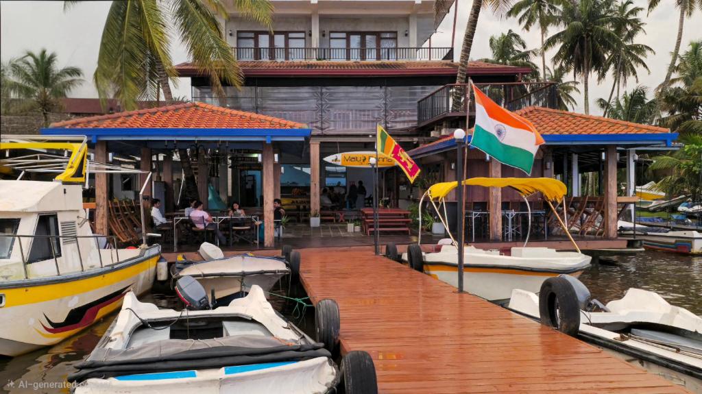 a group of boats docked at a dock at Malu Banna in Aluthgama