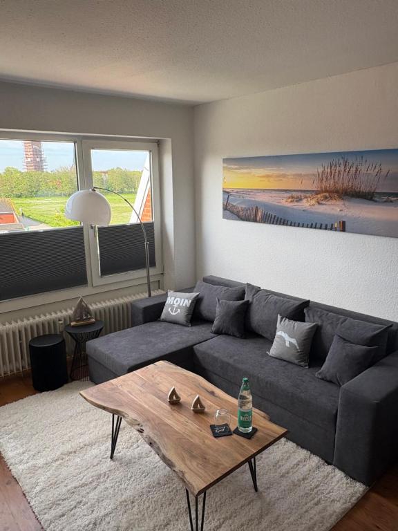 a living room with a couch and a coffee table at Ferienwohnung Fortuna in Borkum