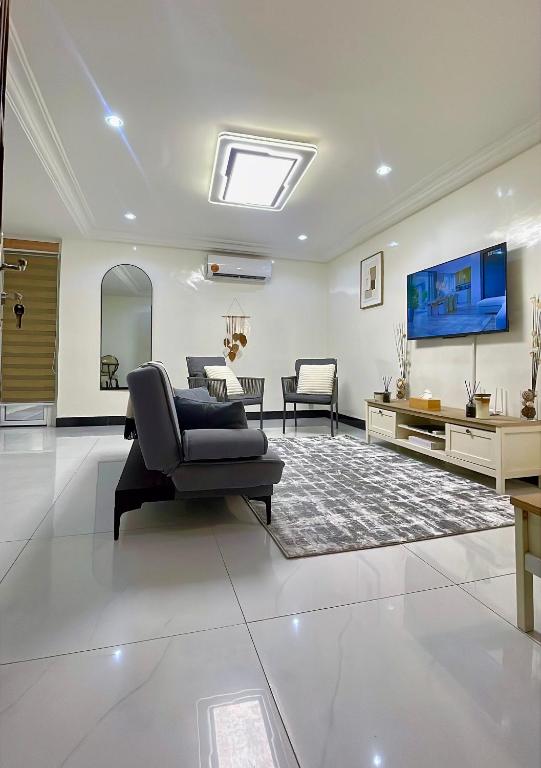 a living room with a couch and a tv at La case Dytobi Mermoz in Dakar
