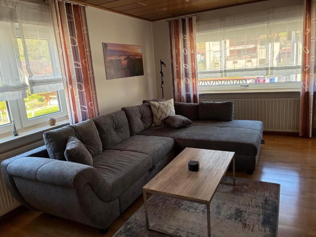 a living room with a couch and a coffee table at Ferienwohnung Felsenidyll in Bundenthal