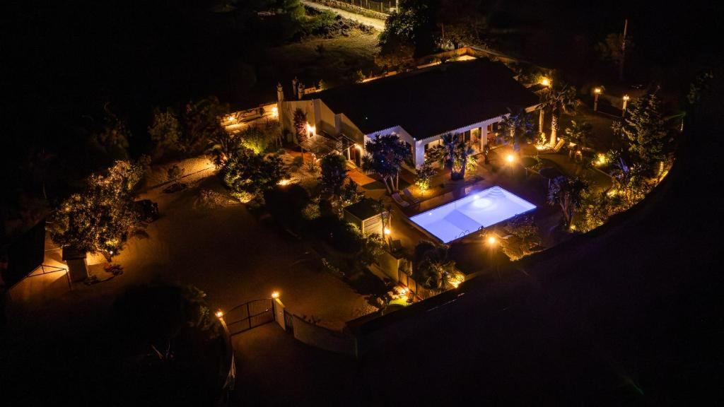an overhead view of a pool at night with lights at Quinta das Amendoeiras B&B in Nora
