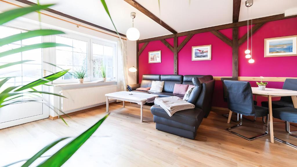 a living room with a couch and a table at Haus an der Pferdekoppel Nr 3 in Fehmarn