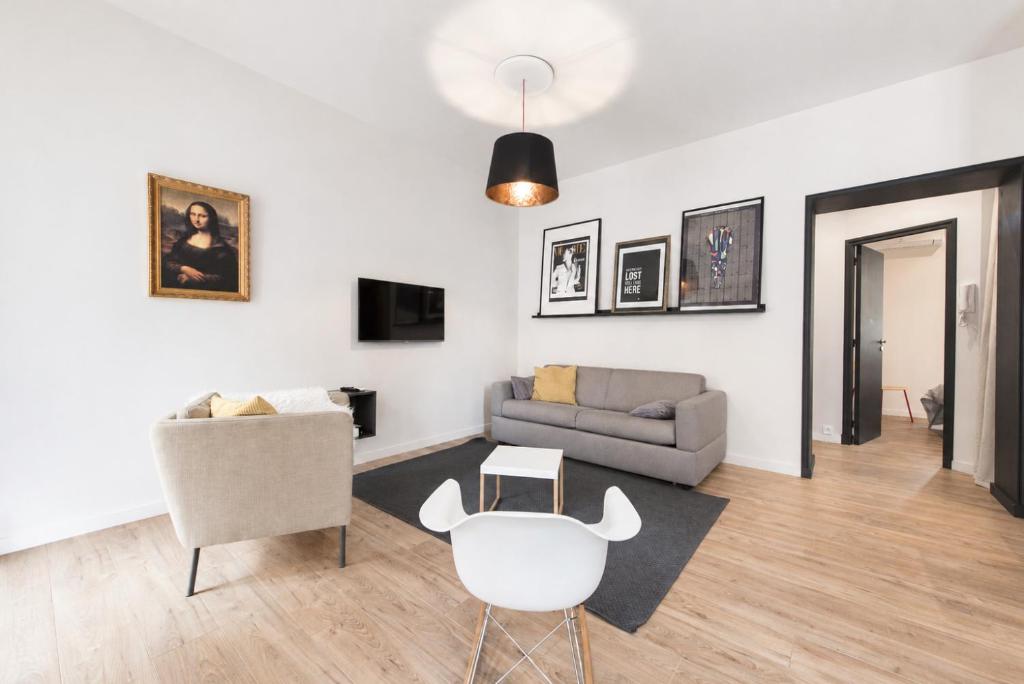 a living room with a couch and a chair at F2 balcon à 1minute de la plage in Saint-Raphaël