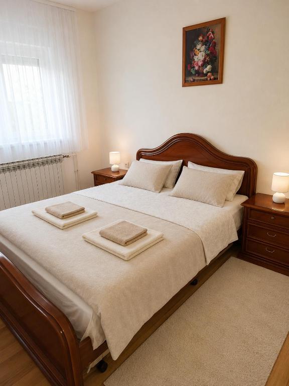 a bedroom with a large bed with two towels on it at Apartman Martina in Gospić