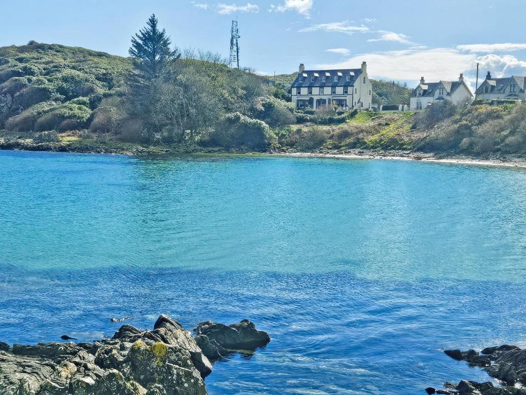 a large body of water with houses in the background at Plover Apartment - Uk51129 in Carradale
