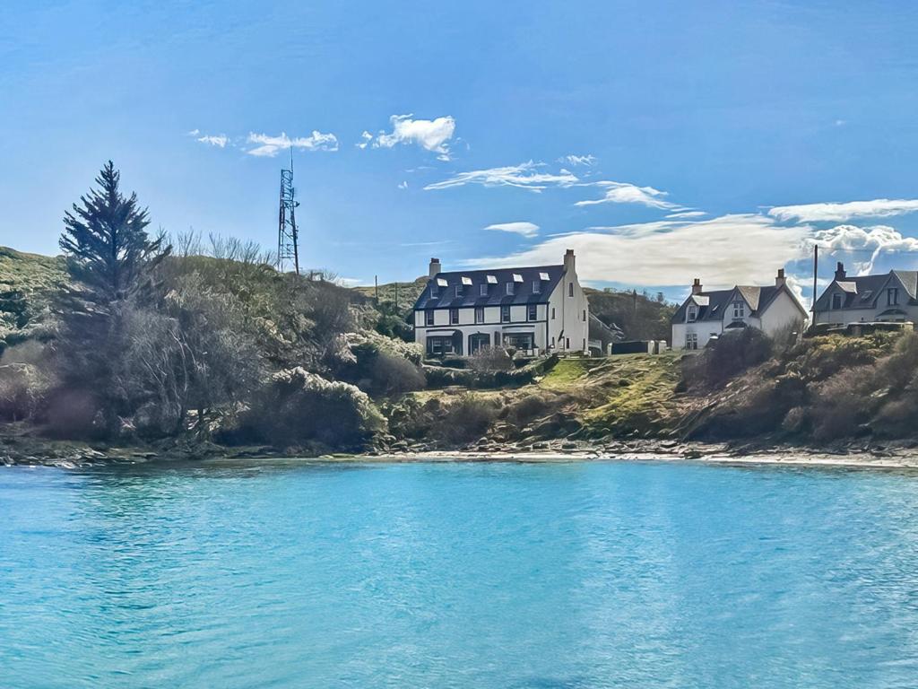 a house on the shore of a body of water at Avocet Apartment - Uk51130 in Carradale