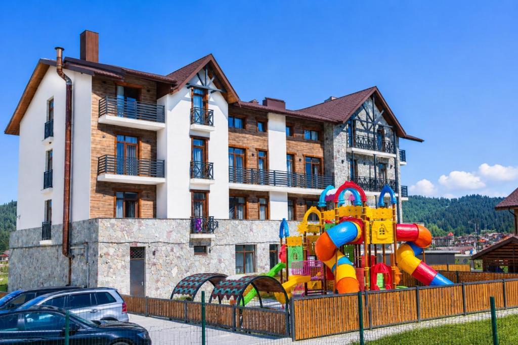 a building with a playground in front of a building at Hotel 25 Bakuriani in Bakuriani