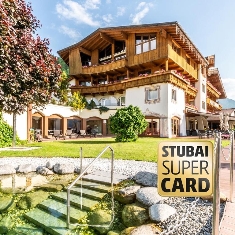 a house with a sign in front of it at Sporthotel Cristall in Fulpmes