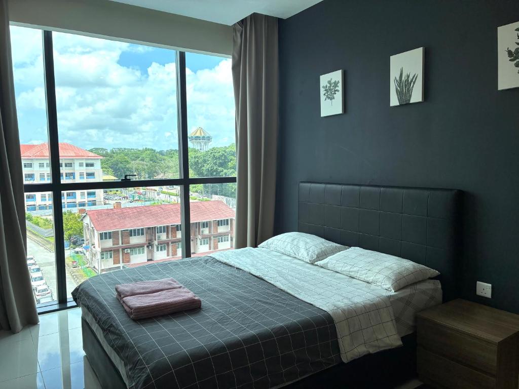 a bedroom with a bed and a large window at Kuching Kozi Square 2paxs Large Window CityView Infinity Pool 2E in Kuching