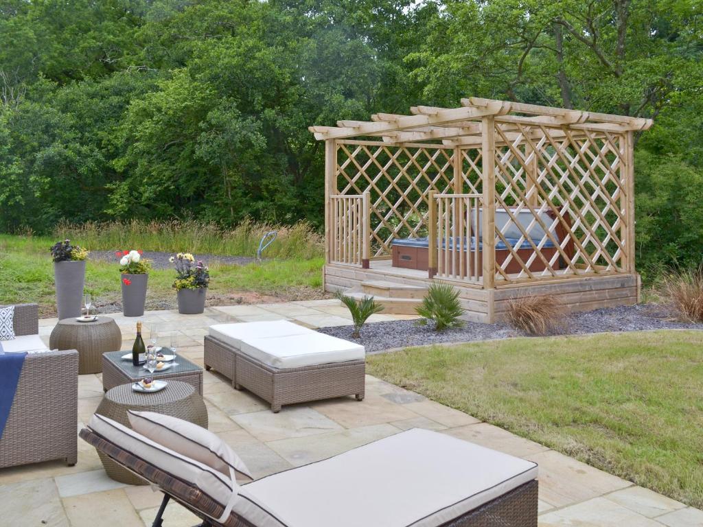 a garden with a gazebo and a patio at Florina in Cheriton Bishop