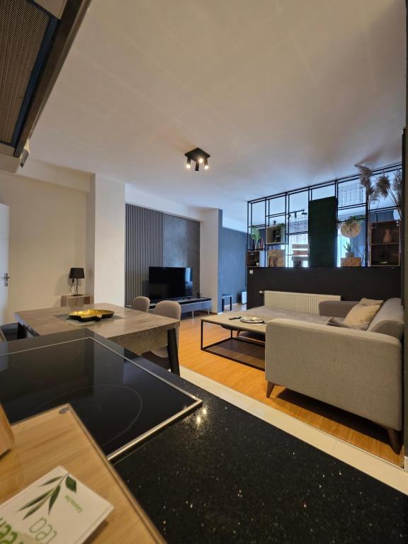 a living room with a couch and a table at Apartment 2 Plisi Gjilan in Gnjilane