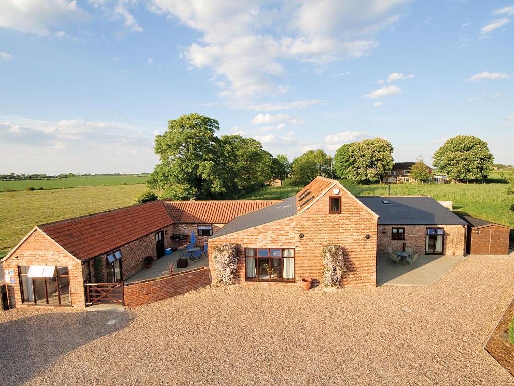 an aerial view of a home with a barn at Harvest Cottage in Anderby