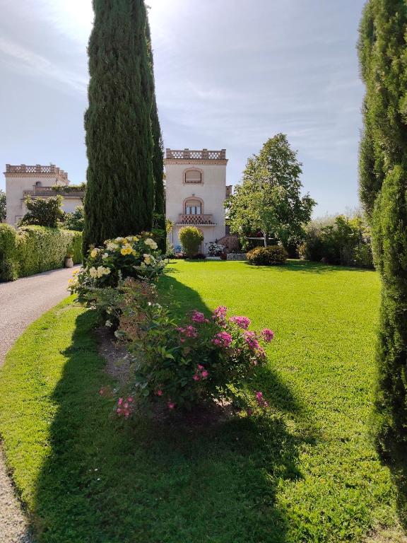 a house with trees and flowers in a yard at B&B Galleria 37 in Canosa Sannita