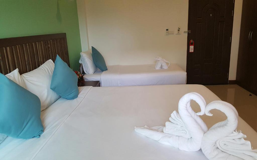 two swans made out of towels on two beds at BS Airport at Phuket in Nai Yang Beach