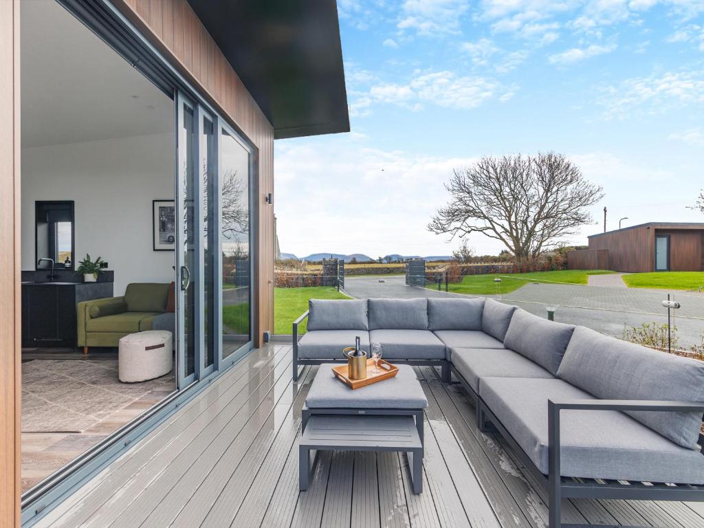 a living room with a couch and a table at Seiriol Lodge 4 - Uk42794 in Llangefni