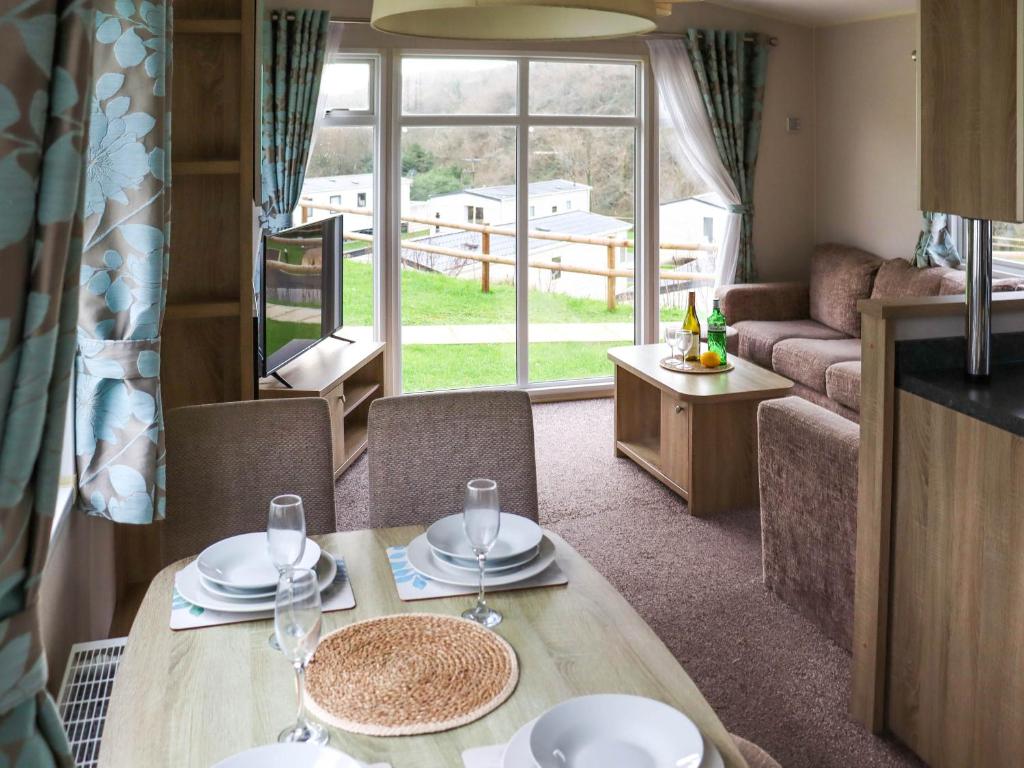 a living room with a table and a couch at Birch 2 - Ukc8215 in Pendine