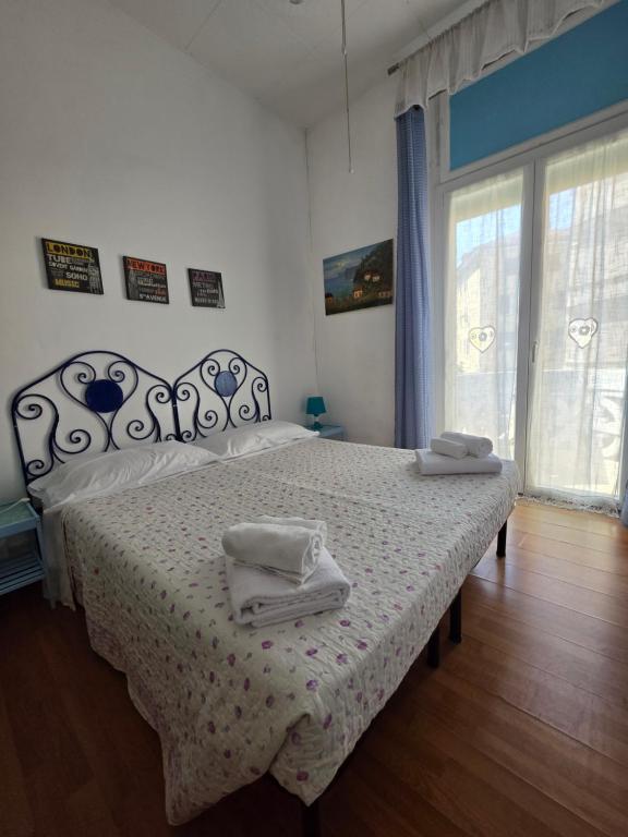 a bedroom with a bed with two towels on it at Villa Cristina in Rapallo