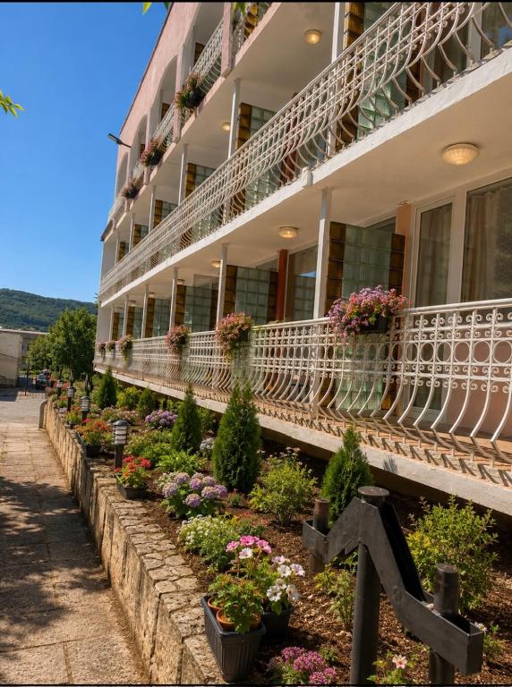 a building with flowers on the side of it at Hotel Olimpiya in Balchik