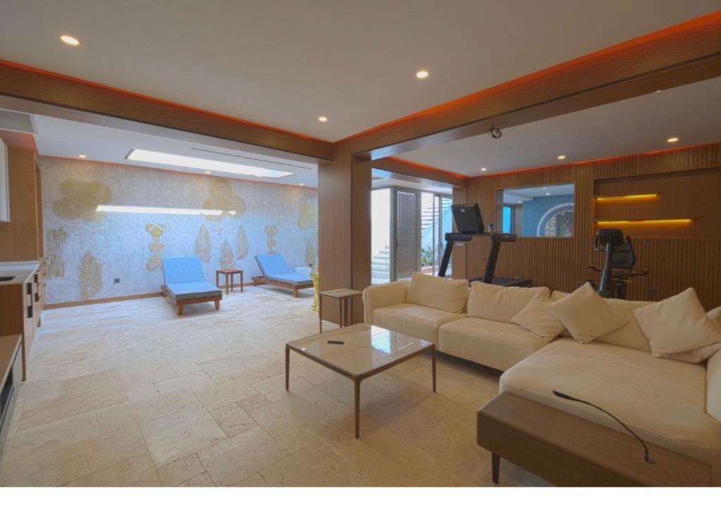 a living room with a couch and a table at Gümüşlük Infinity Villa Seaview, Pool & Sauna in Bodrum City