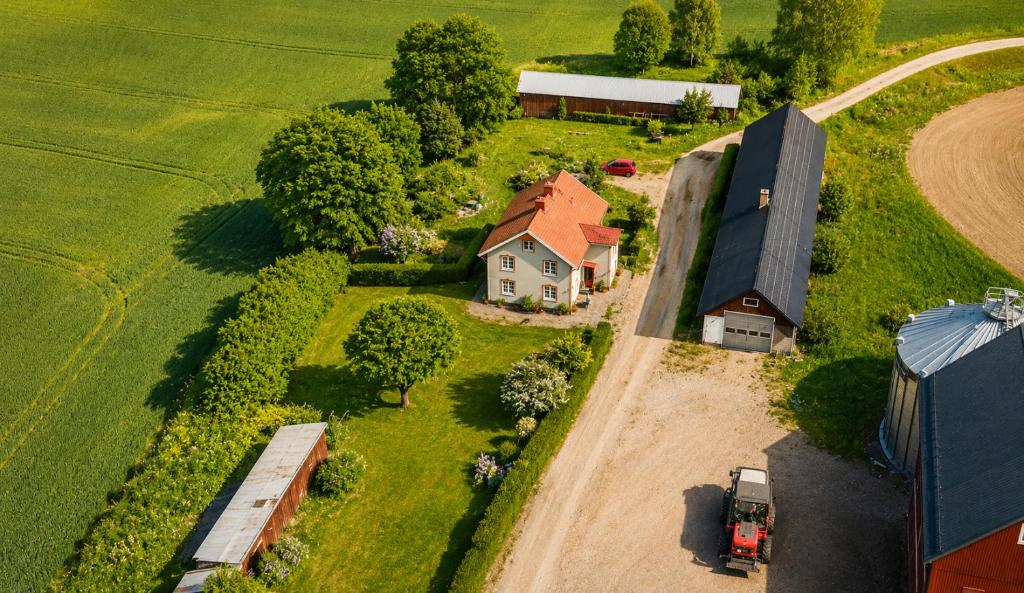 an aerial view of a farm with a house and a truck at Smedstugan in Norrköping