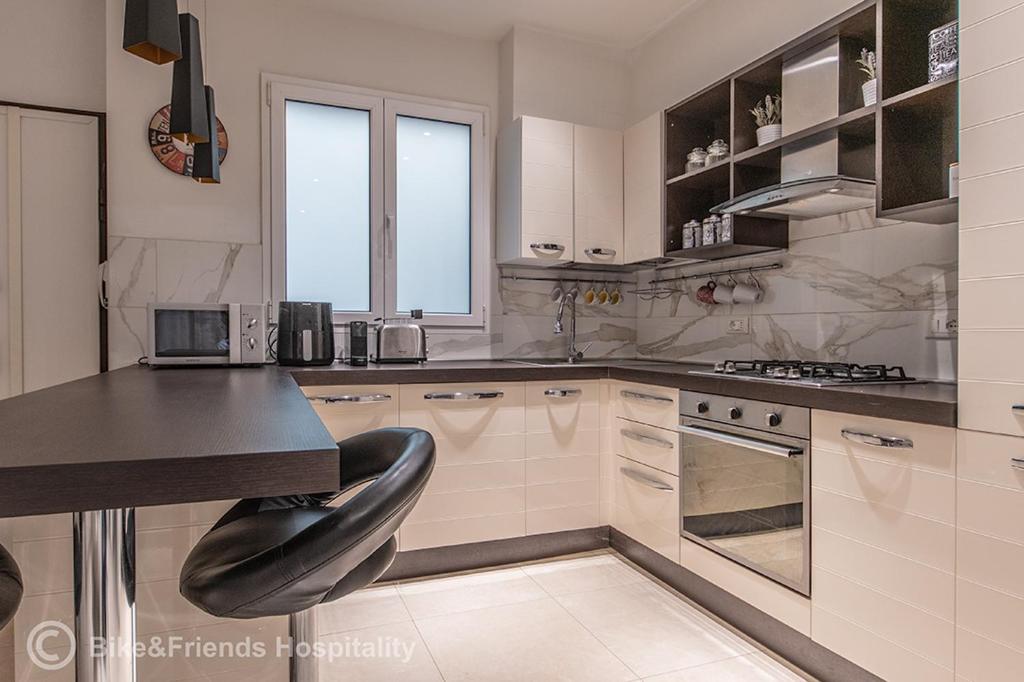 a large white kitchen with a black counter top at Dimora San Francesco in Pesaro