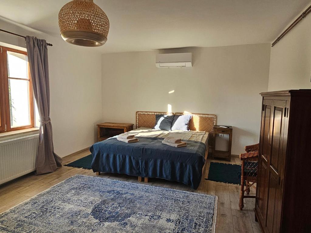 a bedroom with a bed with a blue blanket at Kapolcsi Kuckó in Kapolcs
