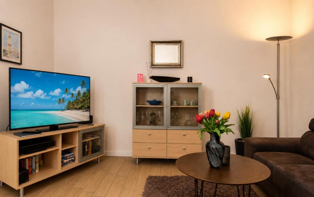 a living room with a flat screen tv at Ferienhaus Alisch Fewo 3 in Warnemünde
