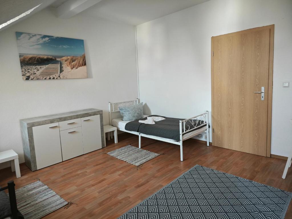 a bedroom with a bed and a cabinet and a door at Revant Monteurzimmer Haus in Arnstadt