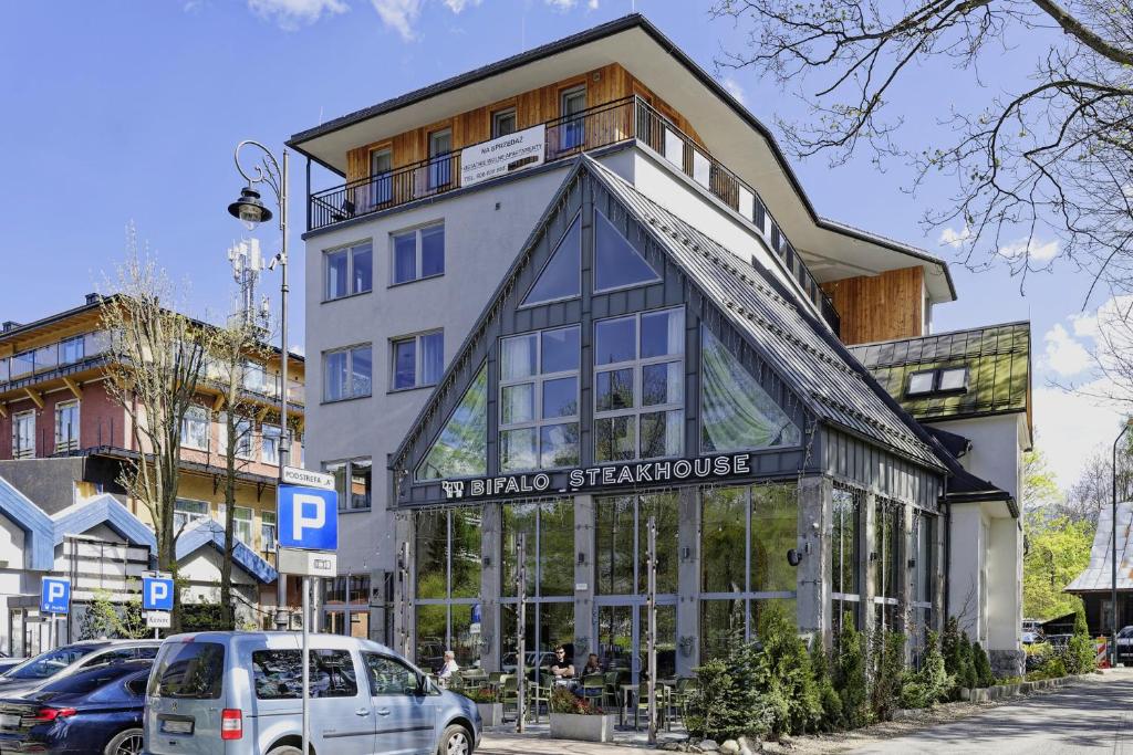 a building with a sign on the front of it at My Mountain View - 50 m od Krupówek in Zakopane