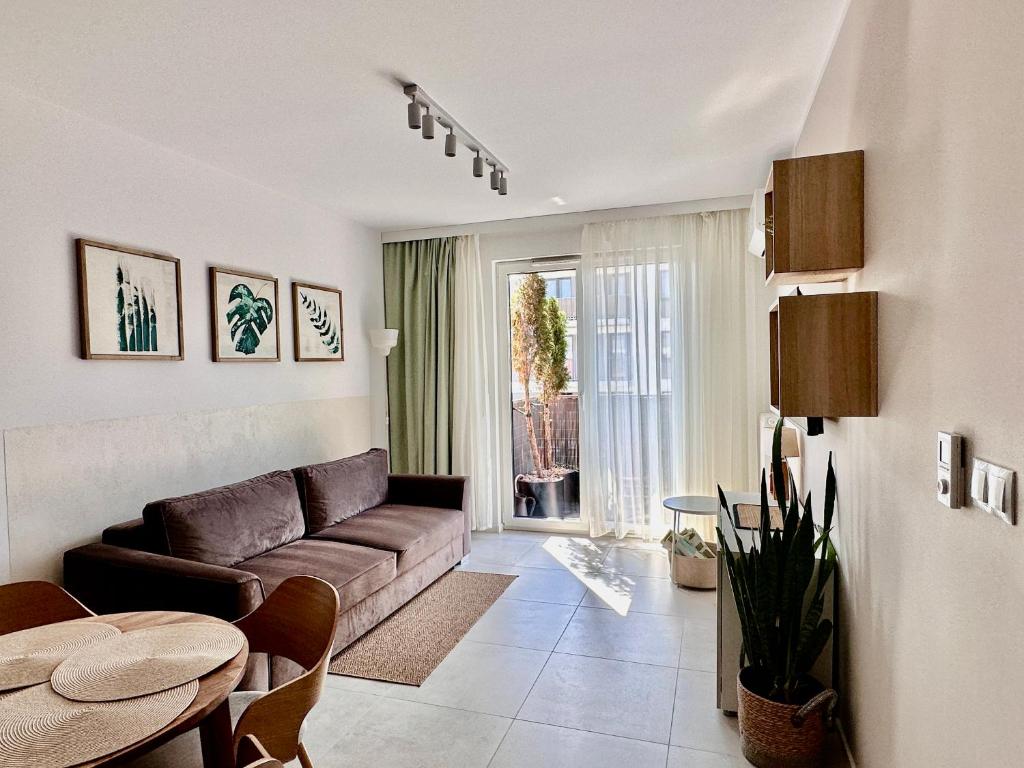 a living room with a couch and a table at Apartment Chrzanòw in Chrzanów