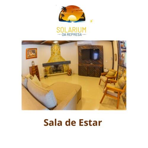 a living room with a couch and a fireplace at Solarium Da Represa in Santa Branca