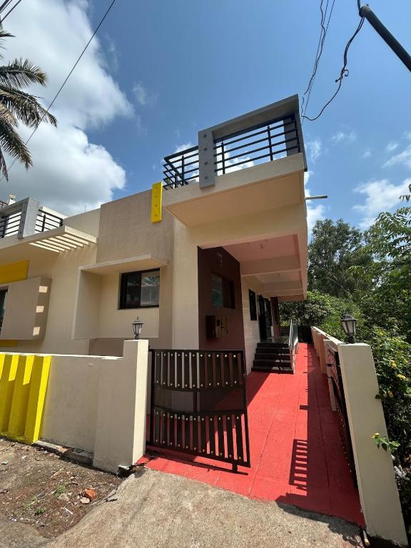 a rendering of a house with a red driveway at RoyalNest Gardenia in Belgaum