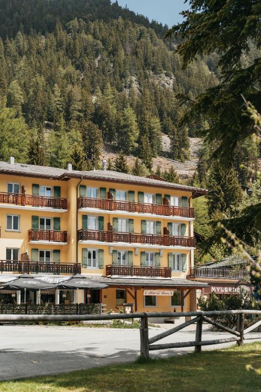 a hotel on a mountain with a fence in front of it at Hôtel du Glacier in Champex