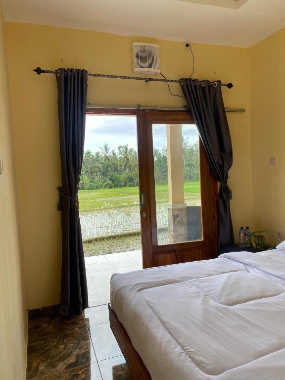 a bedroom with a bed and a large window at Sabin view homestay in Licin