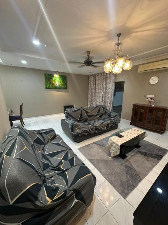 a living room with a couch and a table at Kapar Cozy Homestay in Kapar