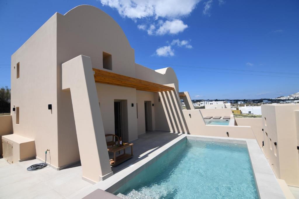 a house with a swimming pool on the roof at Santorini - Villa - Sleeps 4 - Pool - Parking in Mesaria