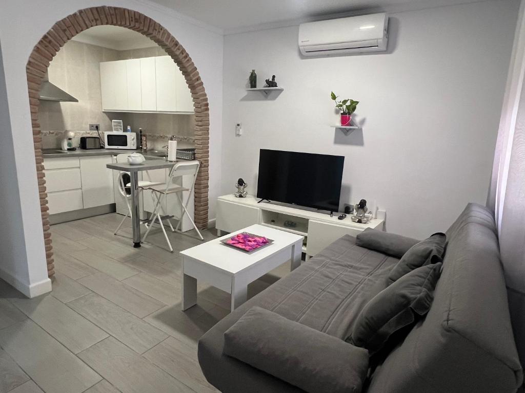 a living room with a couch and a table at Estudio Bajamar in Torre del Mar