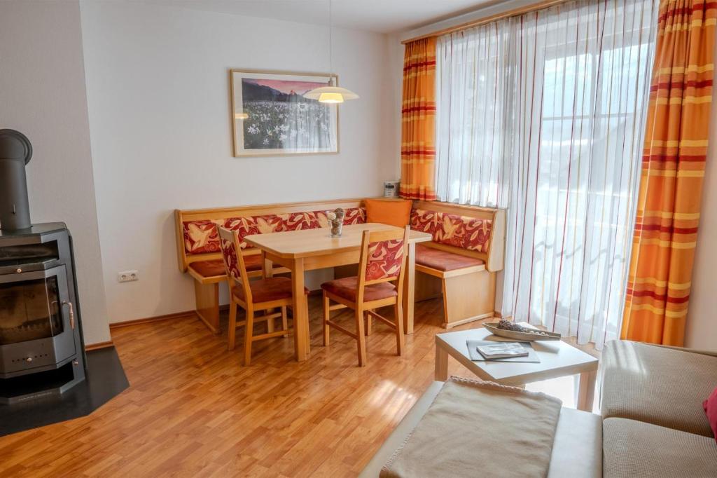 a living room with a table and a couch at Ferienwohnung Schretthauser in Bad Mitterndorf