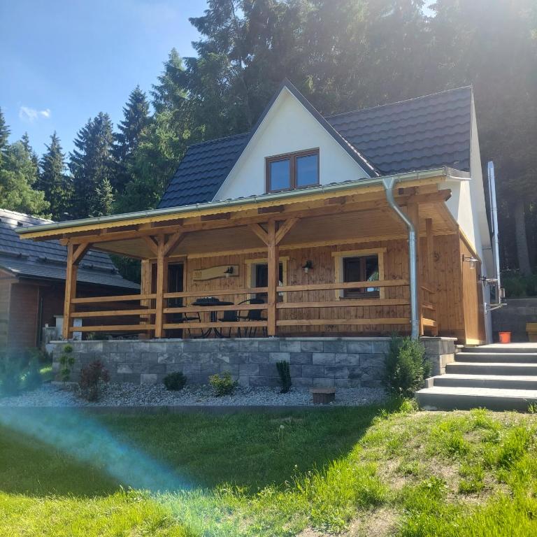a large wooden house with a roof at Chata Jeřabina in Klíny