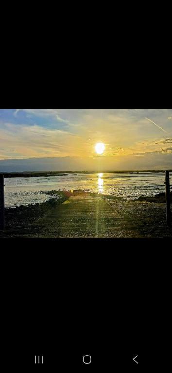 a picture of a sunset on the beach at Steeple Bay E68 in Steeple