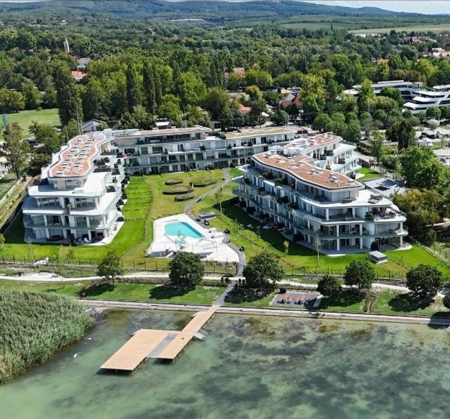 an aerial view of a large building next to the water at Waterfront studio in Balatonszemes