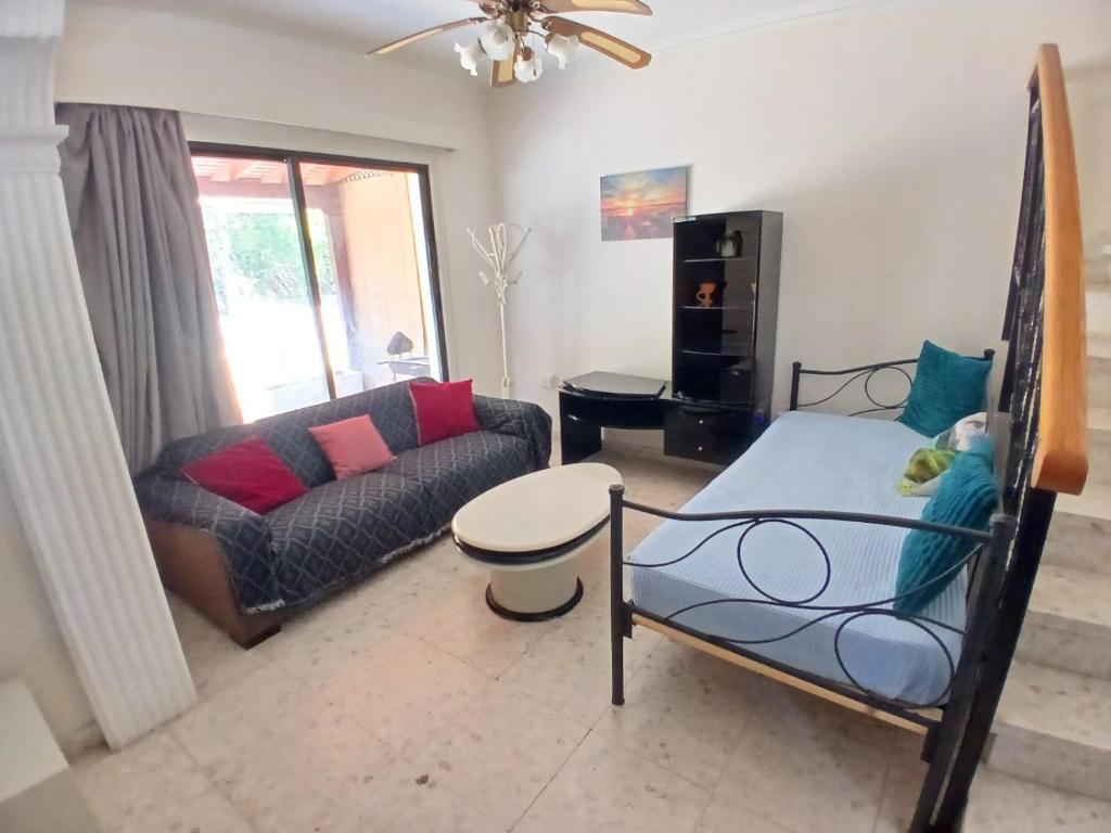 a living room with a couch and a table at Miltos beach House in Larnaca
