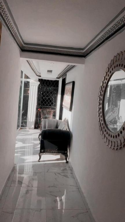 a living room with a chair and a mirror at Apartament BC in San Cristóbal