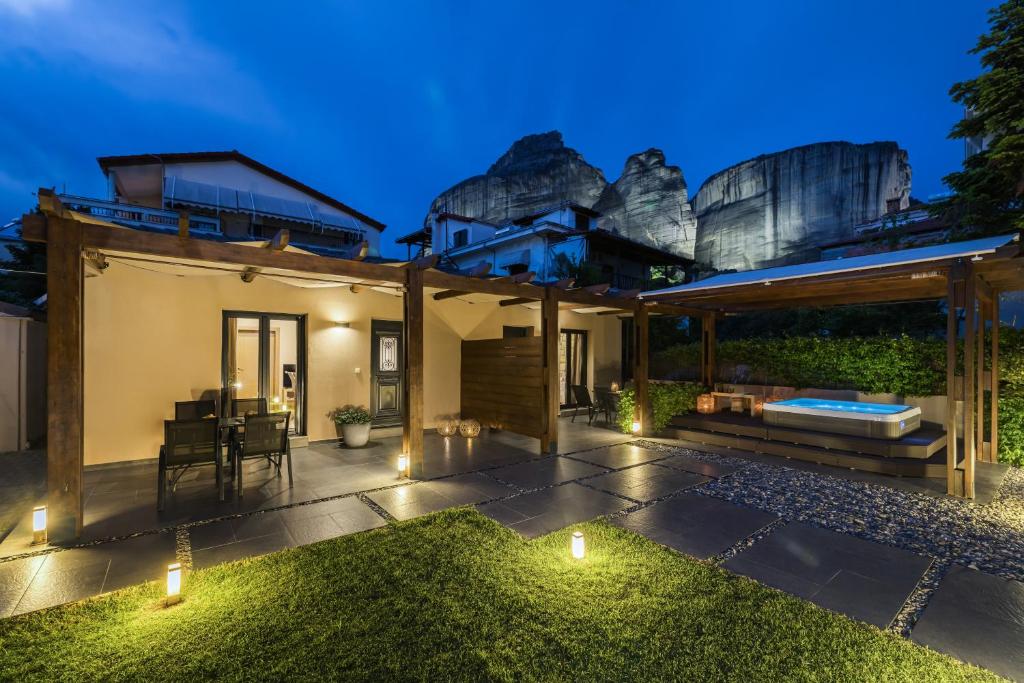 a home with a lit up patio at night at Meteora boutique villa A in Kalabaka
