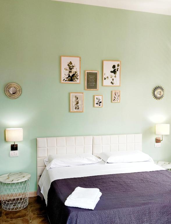 a bedroom with a large bed with a blue wall at Le Suite dei Due Mari cucinino privato in Taranto