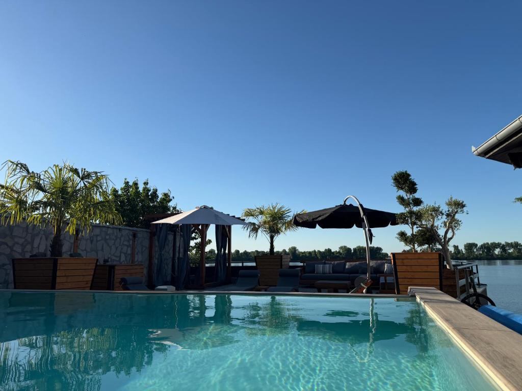 a swimming pool with a view of the water at Aurum Etno & Spa in Smederevo