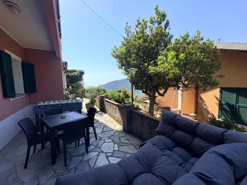 a couch and a table and chairs on a patio at Relax Between Cinque Terre and Portofino in Moneglia