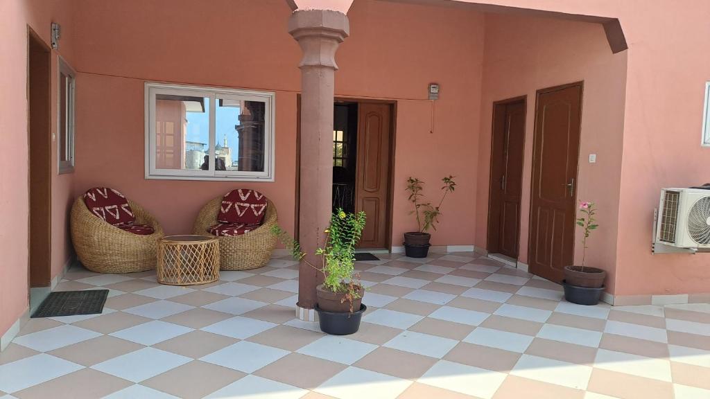 a porch with potted plants on a house at DAVADI loc in Cotonou