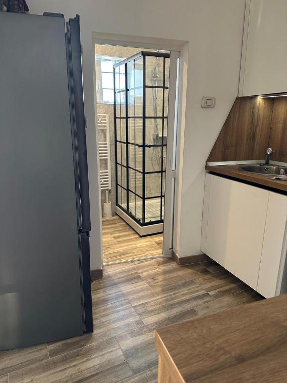 a kitchen with a sink and a door to a room at Casa Andora Brașov in Braşov